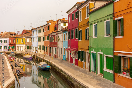 Italy, Venice, Burano, canals and boats among the typical colored houses. © benny