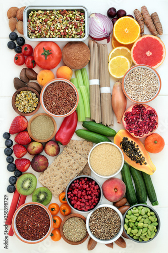 Health food for weight loss with fresh fruit and vegetables, whole grain noodles and crackers, grains, seeds and nuts with herbs used in herbal medicine to suppress appetite. Top view.