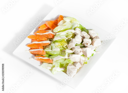 Fresh delicious healthy salad with celery, carrot and meat on white