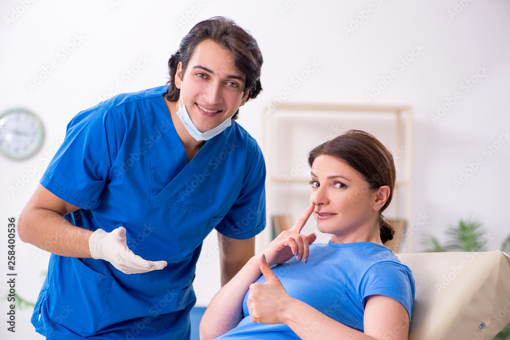 Woman visiting male doctor for plastic surgery Woman visiting male doctor for plastic surgery