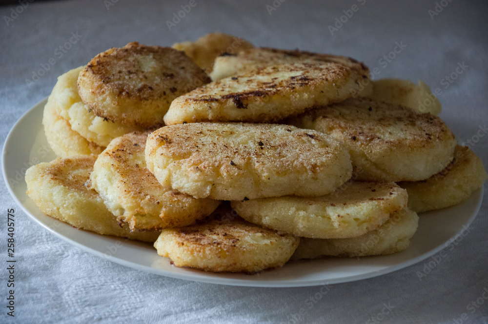 Hot tasty baked cheese pancakes in the plate standing on the gas stove. Breakfast Hot tasty baked cheese pancakes in the plate standing on the gas stove. Breakfast