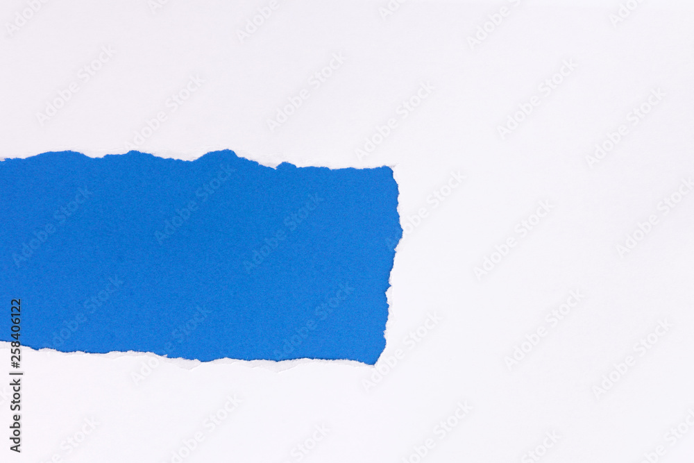 White torn paper over blue background with pencil White torn paper over blue background with pencil