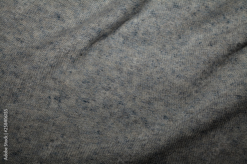 Texture of wool gray fibers with a rough surface, background, abstraction. Space for text. Gray fabric.