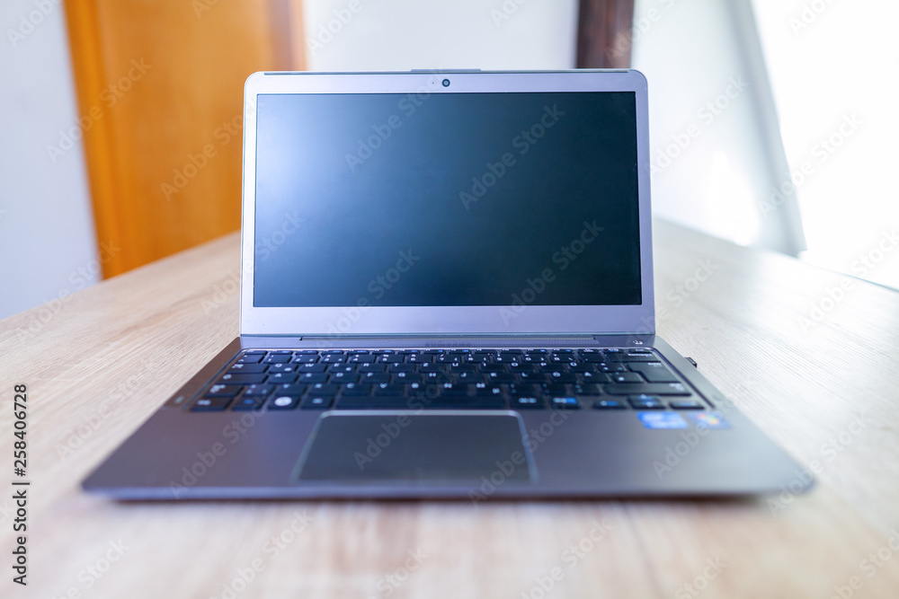 Fototapeta premium A clean laptop stands on a table