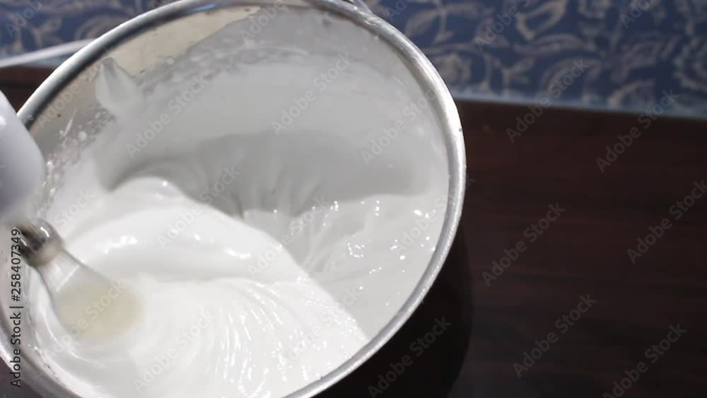 Stock video Close up: Whisks whipped egg whites and sugar in metal bowl. Whisk bowl of raw egg in real time. Whisk for whipping. Whip the egg white: cook at home, make a cake, dessert, meringue Stock video Close up: Whisks whipped egg whites and sugar in metal bowl. Whisk bowl of raw egg in real time. Whisk for whipping. Whip the egg white: cook at home, make a cake, dessert, meringue