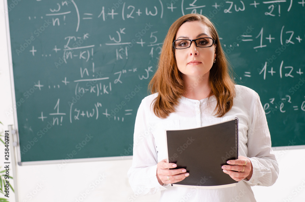 Female math teacher in the classroom Female math teacher in the classroom