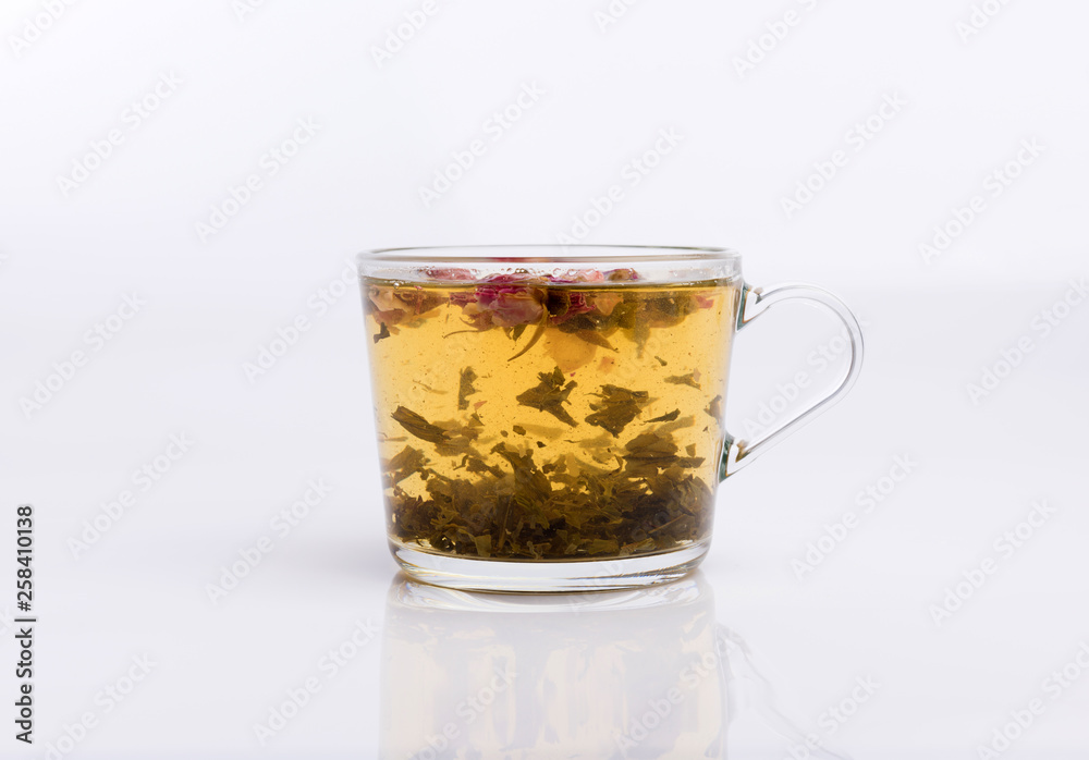 Glass cup of hot aromatic roses tea on white background Glass cup of hot aromatic roses tea on white background