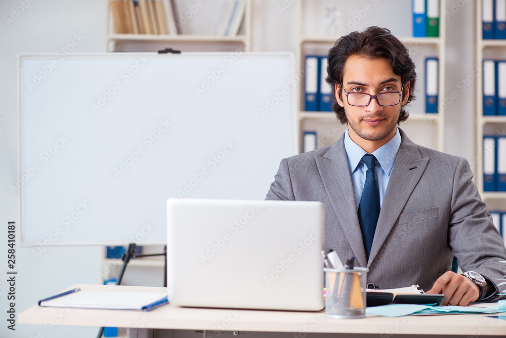 Young handsome businessman in budget planning concept Young handsome businessman in budget planning concept