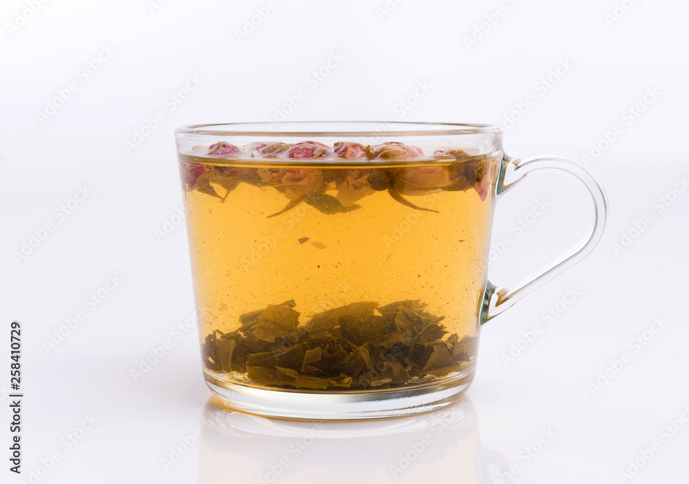 Glass cup of green tea with roses. Isolated on white background Glass cup of green tea with roses. Isolated on white background
