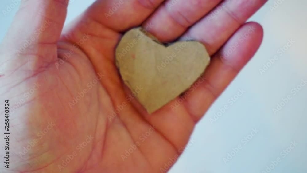 heart made of paper lies on the palm heart made of paper lies on the palm