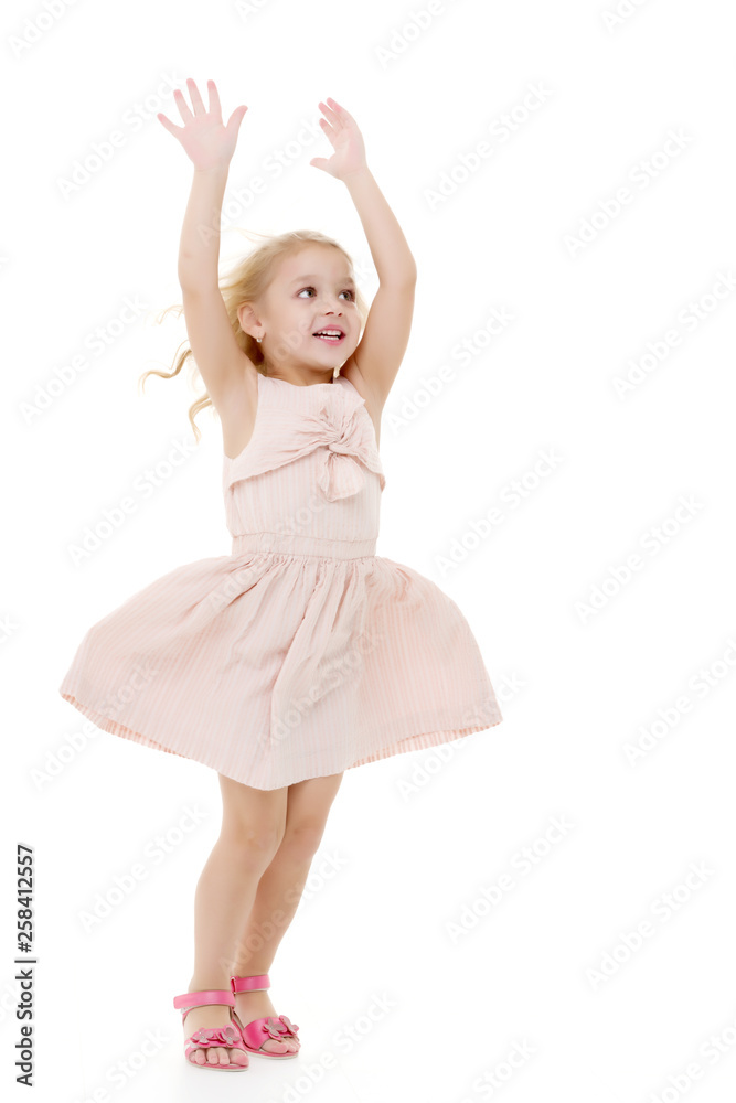 Obraz premium Little girl in a dress developing in the wind.