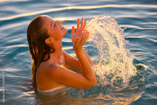 Young woman splashing her face