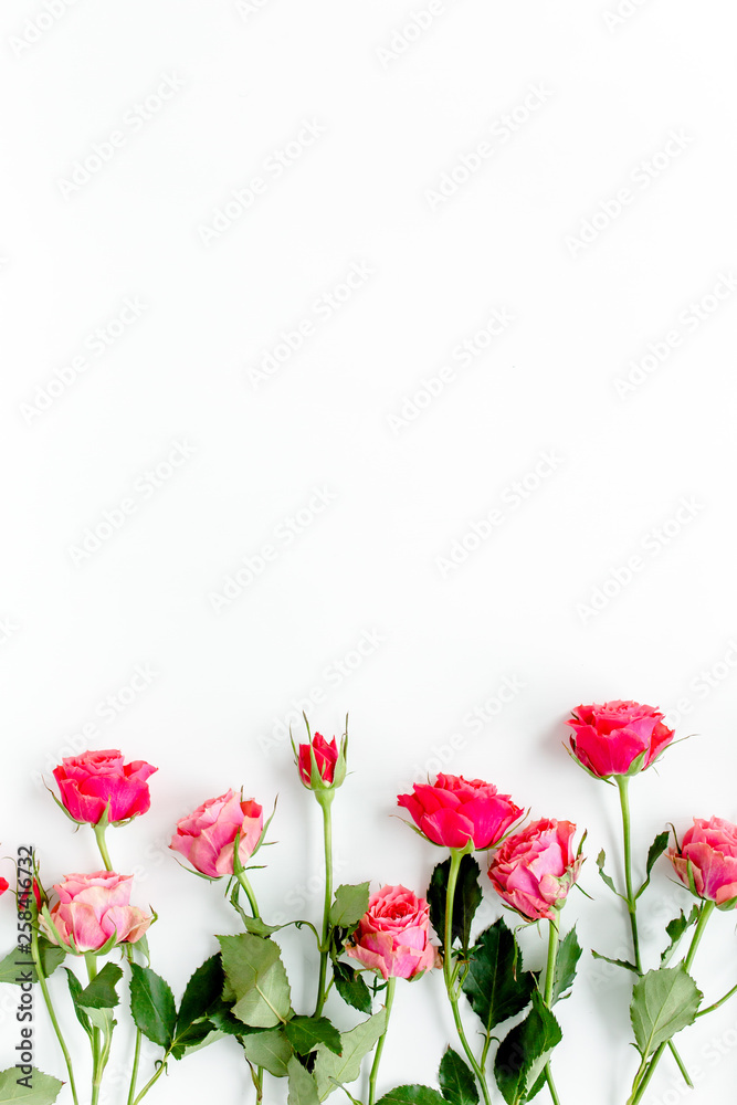 Floral pattern made of red roses and branches on white background. Valentine's background. Floral pattern. Flat lay, top view. 