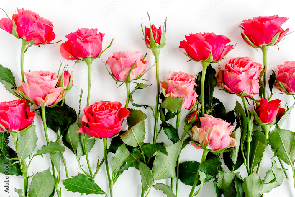 Floral pattern made of red roses and branches on white background. Valentine's background. Floral pattern. Flat lay, top view. 