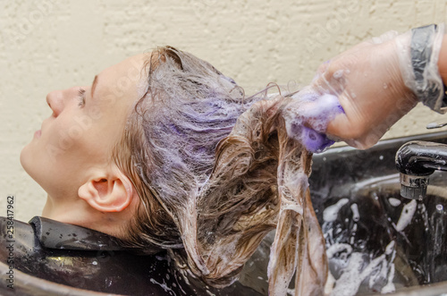 Hairdresser apply purple hair to hair blonde photo