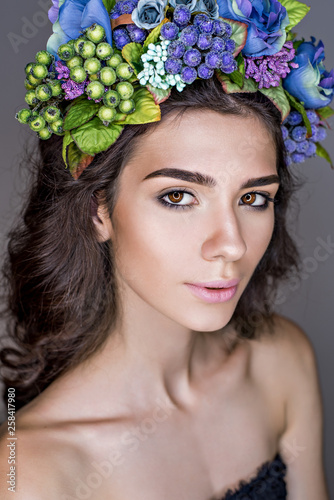 Beautiful girl with a flower wreath on her head. Fashion and beauty shooting! Incredible girl in flowers