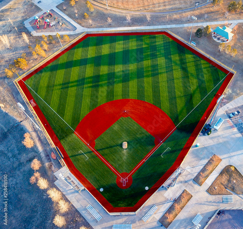 Photography Aerial drone wide angle view of a green baseball field diamond in the morning sunlight ready for play