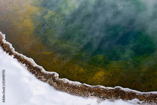 Colorful geyser basin in winter photo