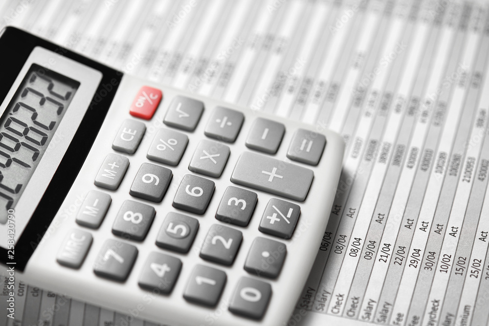 Calculator and reports closeup. Office supplies for working and calculating finance. Business financial accounting concept. Calculator and reports closeup. Office supplies for working and calculating finance. Business financial accounting concept.