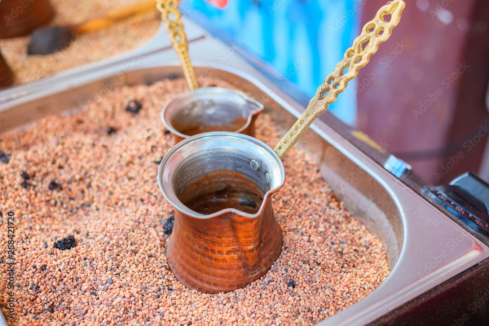 Preparation coffee in cezve on hot sand. Preparation coffee in cezve on hot sand.