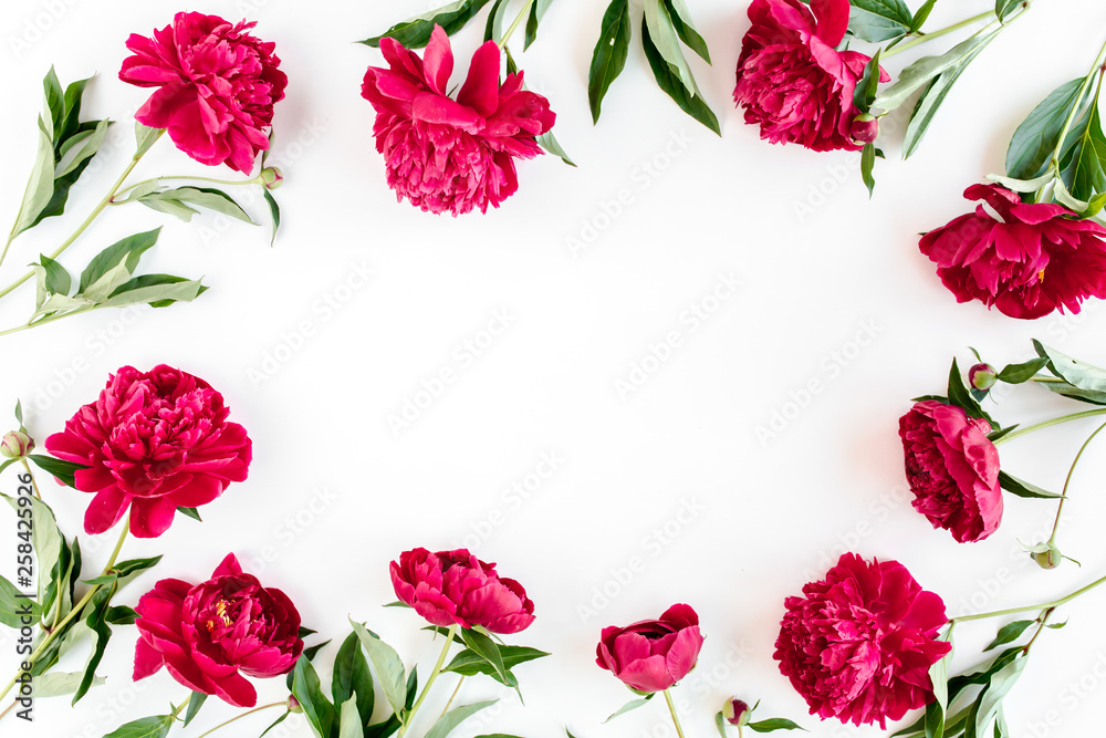 Frame made of beautiful red peonies on white background. Flat lay, top view. Valentine's background. Floral frame. Peony texture.