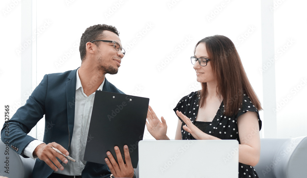 business team discusses the documents sitting in the office lobby business team discusses the documents sitting in the office lobby