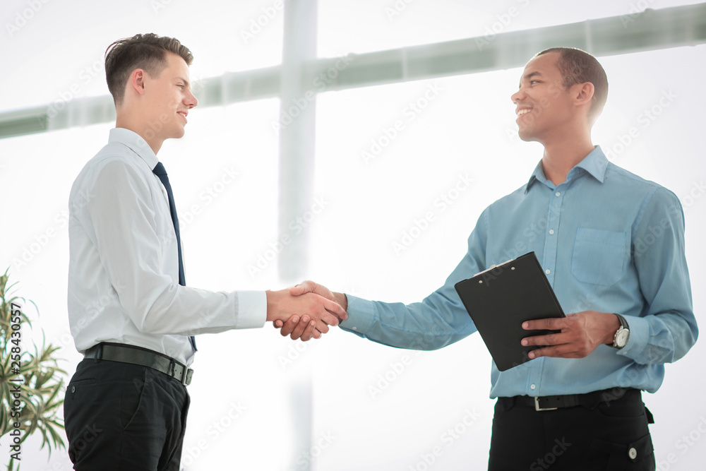 friendly business people shaking hands on blurred background friendly business people shaking hands on blurred background