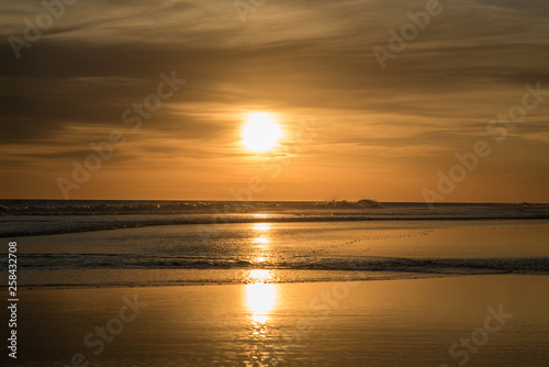 Sunset over the sea  sun reflected in the water  orange sunset  gentle waves and the brightness of the sun
