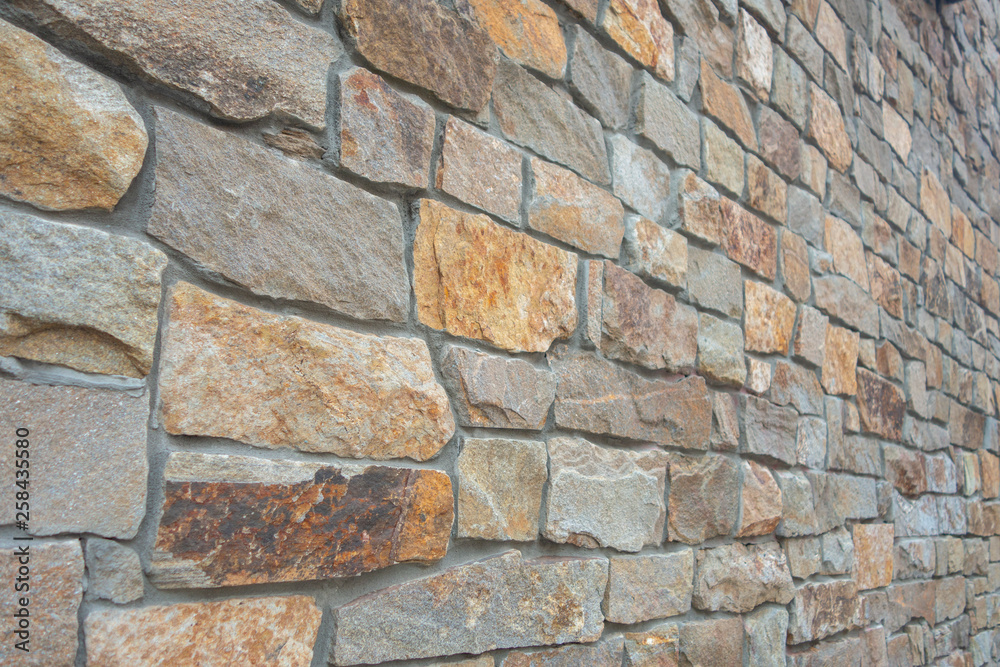 Fototapeta premium big solid stone cement wall in a perspective angle