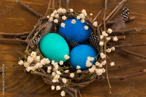 Easter decoration of painted eggs on a wooden background.