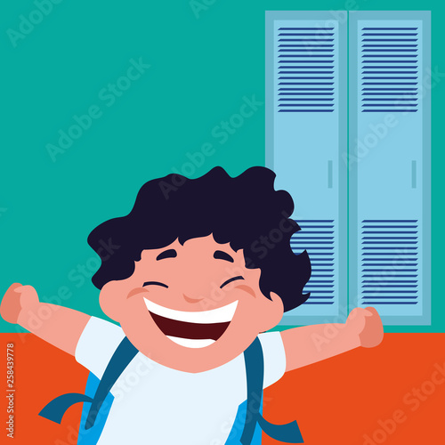little schoolboy with schoolbag in school corridor
