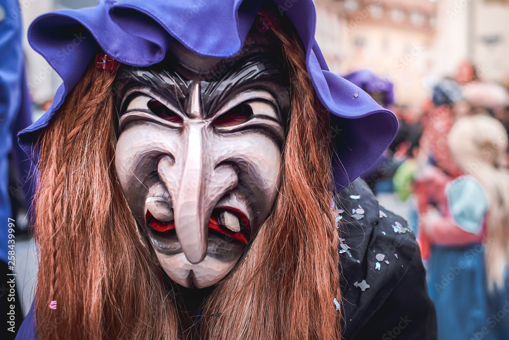 Pretty witch with long nose, violet hat and brown hair. Street Carnival in Southern Germany - Black Forest. Pretty witch with long nose, violet hat and brown hair. Street Carnival in Southern Germany - Black Forest.