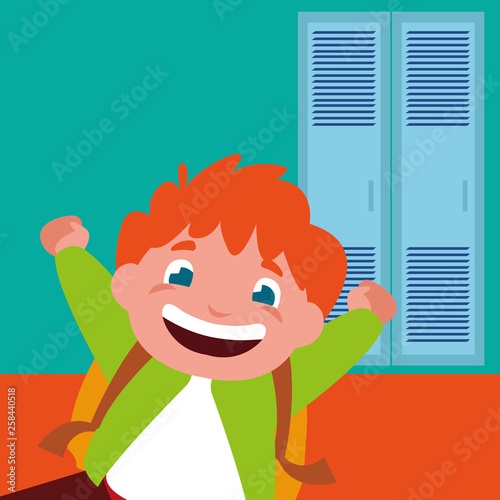 little schoolboy with schoolbag in school corridor
