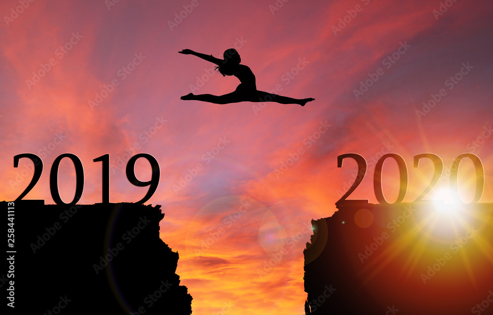 Sunrise Silhouette of Girl Leaping Over Cliff Toward New Year 2020 Sunrise Silhouette of Girl Leaping Over Cliff Toward New Year 2020