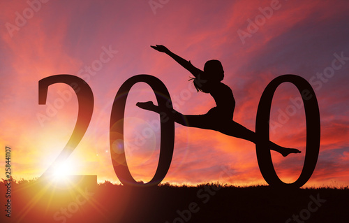 2020 New Year Silhouette of Girl Dancing at Golden Sunrise