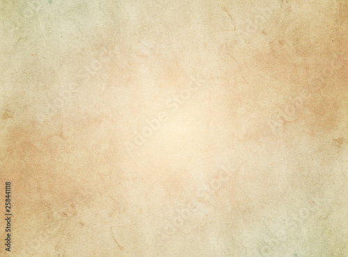 An elegant, beige, tan, grunge parchment texture background with glowing center Fototapet