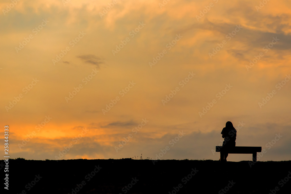 silhouette of woman relax on chair happy time sunset