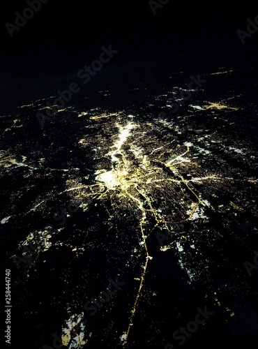 Flying at night over cities below photo