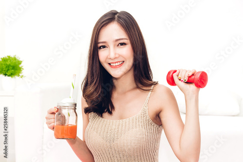 Sport woman in sportswear relax and drink fresh juice after workout.Diet concept.Fitness and healthy lifestyle photo