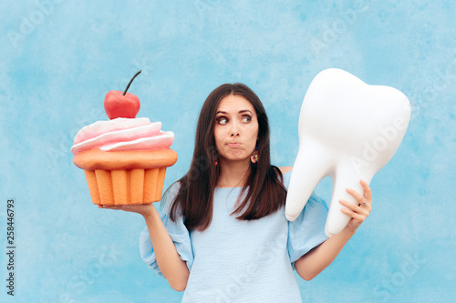Funny Woman Holding Big Cupcake and Tooth  photo