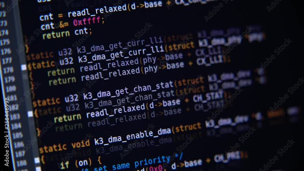 The program code scrolls on the computer screen