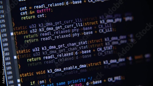 The program code scrolls on the computer screen