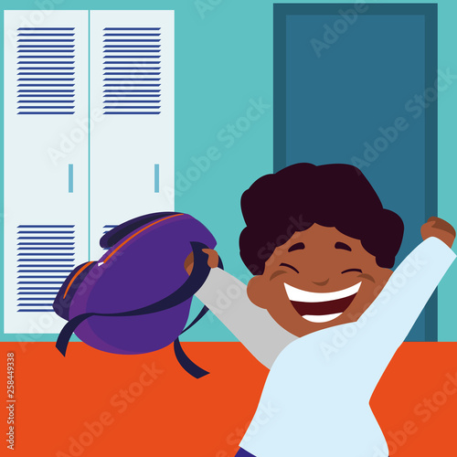 little black schoolboy with schoolbag in school corridor