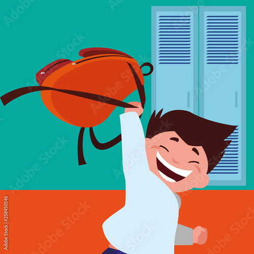 little schoolboy with schoolbag in school corridor