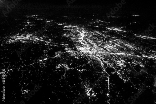 Flying at night over cities below photo