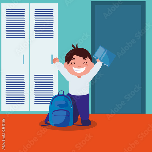 little schoolboy with schoolbag in school corridor