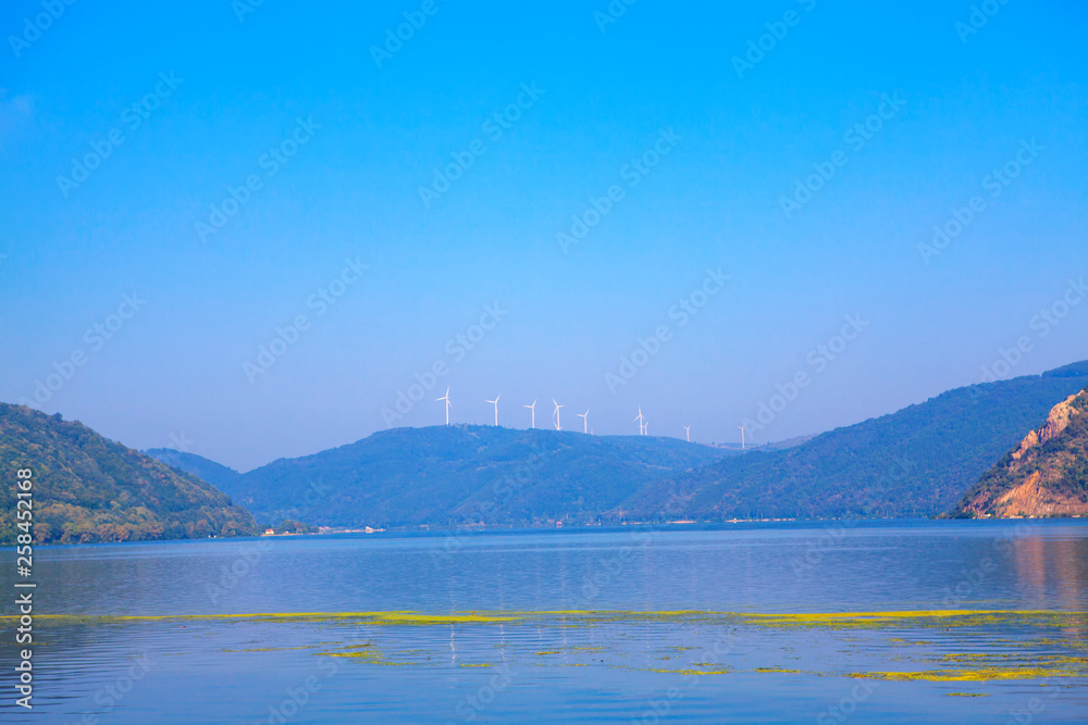 beautiful scenery with wind mills on the hill