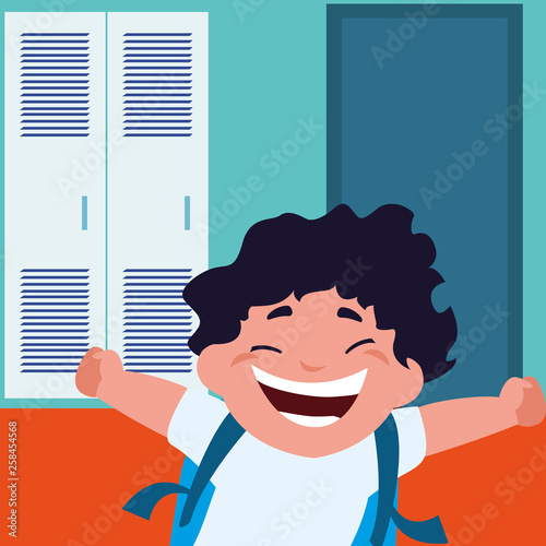 little schoolboy with schoolbag in school corridor