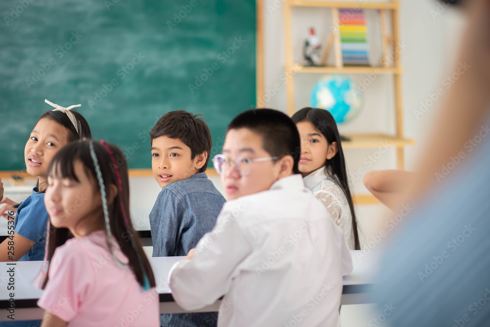 Asian primary student and teacher in the classroom Asian primary student and teacher in the classroom
