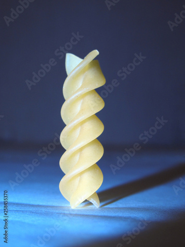 Single screw pasta on the blue background